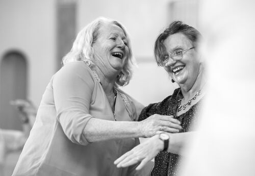 Participants laughing in black and white