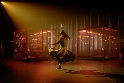 A solo dancer in movement on stage