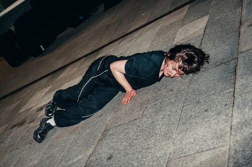 A dancer lying down on the ground