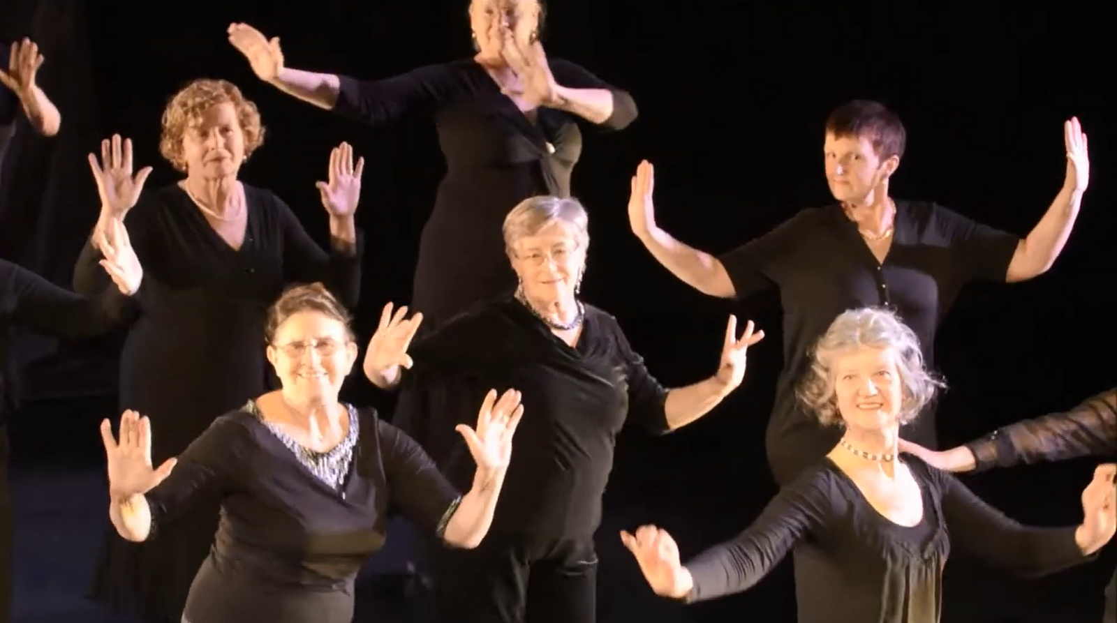 Older people in a movement with raised hands